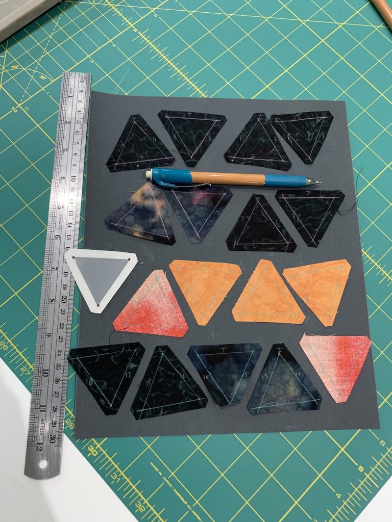 A row of triangles arranged on sandpaper