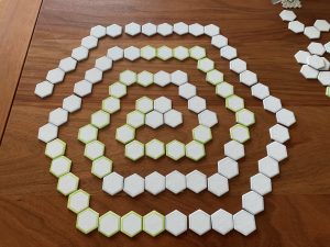 Die-cut hexagons arranged in a spiral, on a wooden table